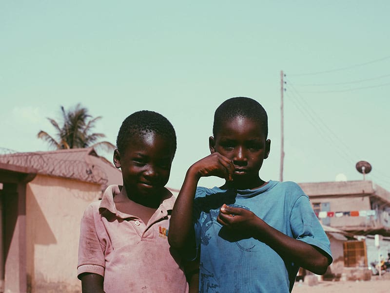 Two young boys standing next to each other.