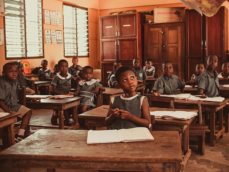 A group of children sitting at desks in a classroom.