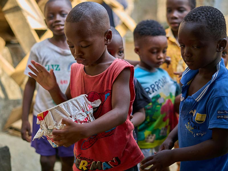 A group of children standing around each other.
