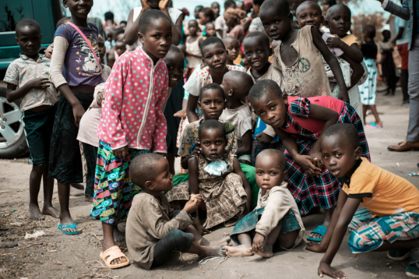 A group of children sitting on the ground.