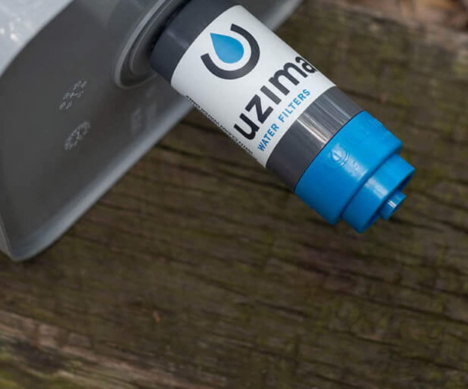 A blue and white bottle of water on top of a wooden table.